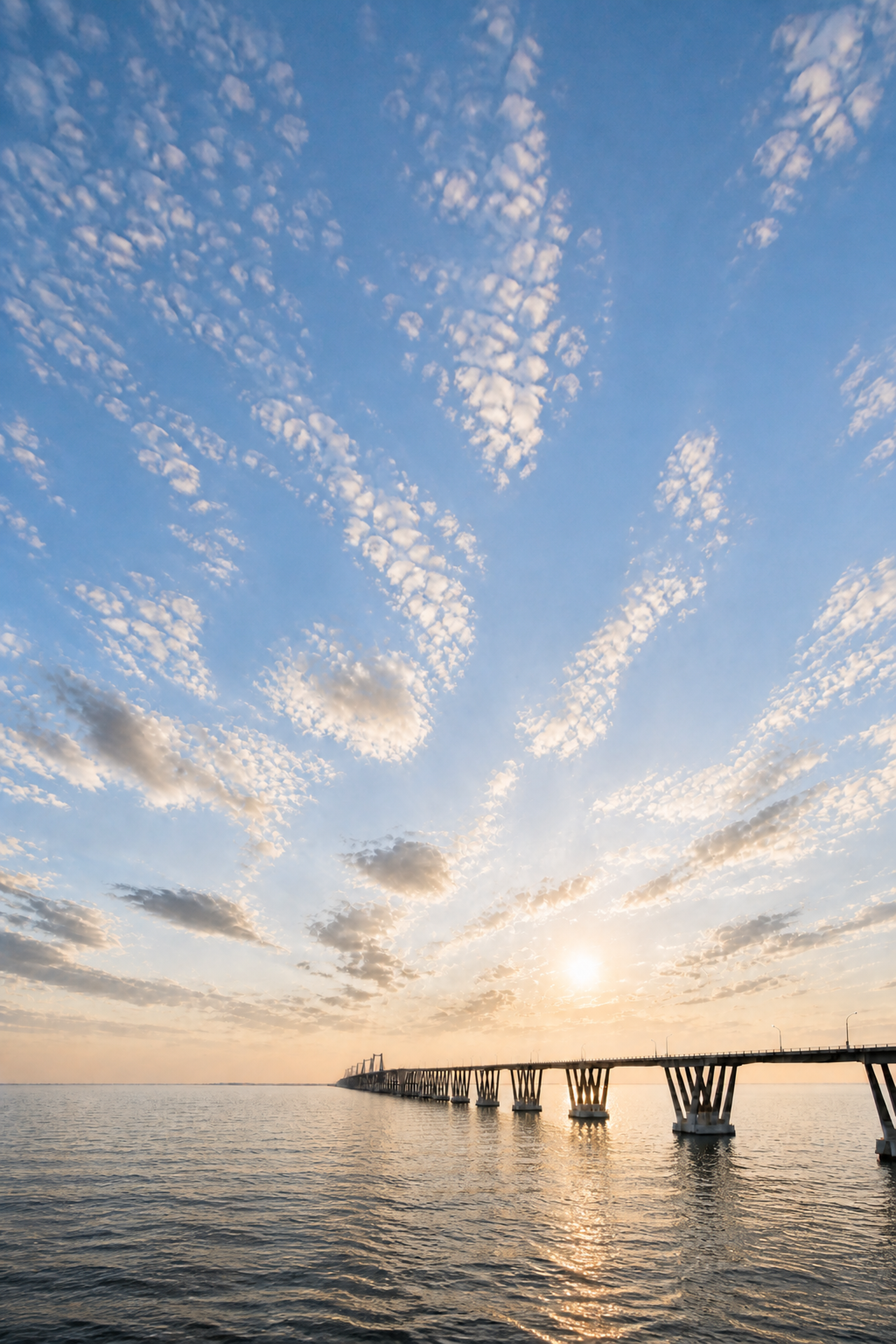 Lake Maracaibo and the General Rafael Urdaneta Bridge beneath a bright golden-hour sky